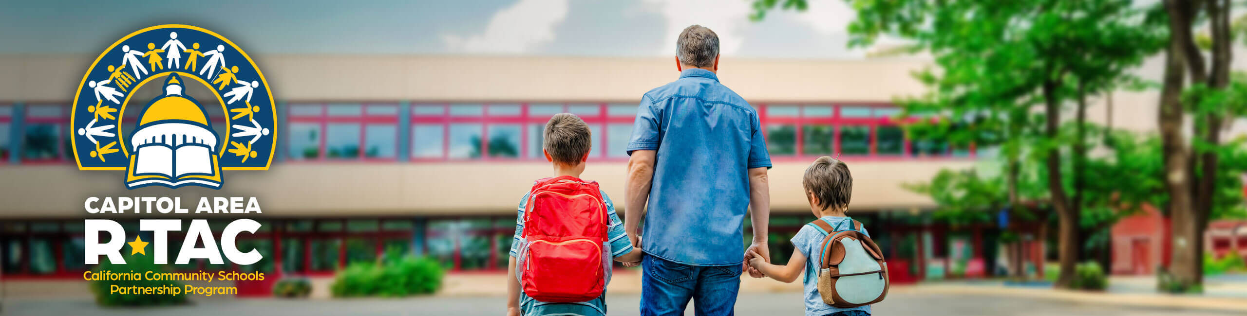Hand-in-hand, a father leads his two children to school.